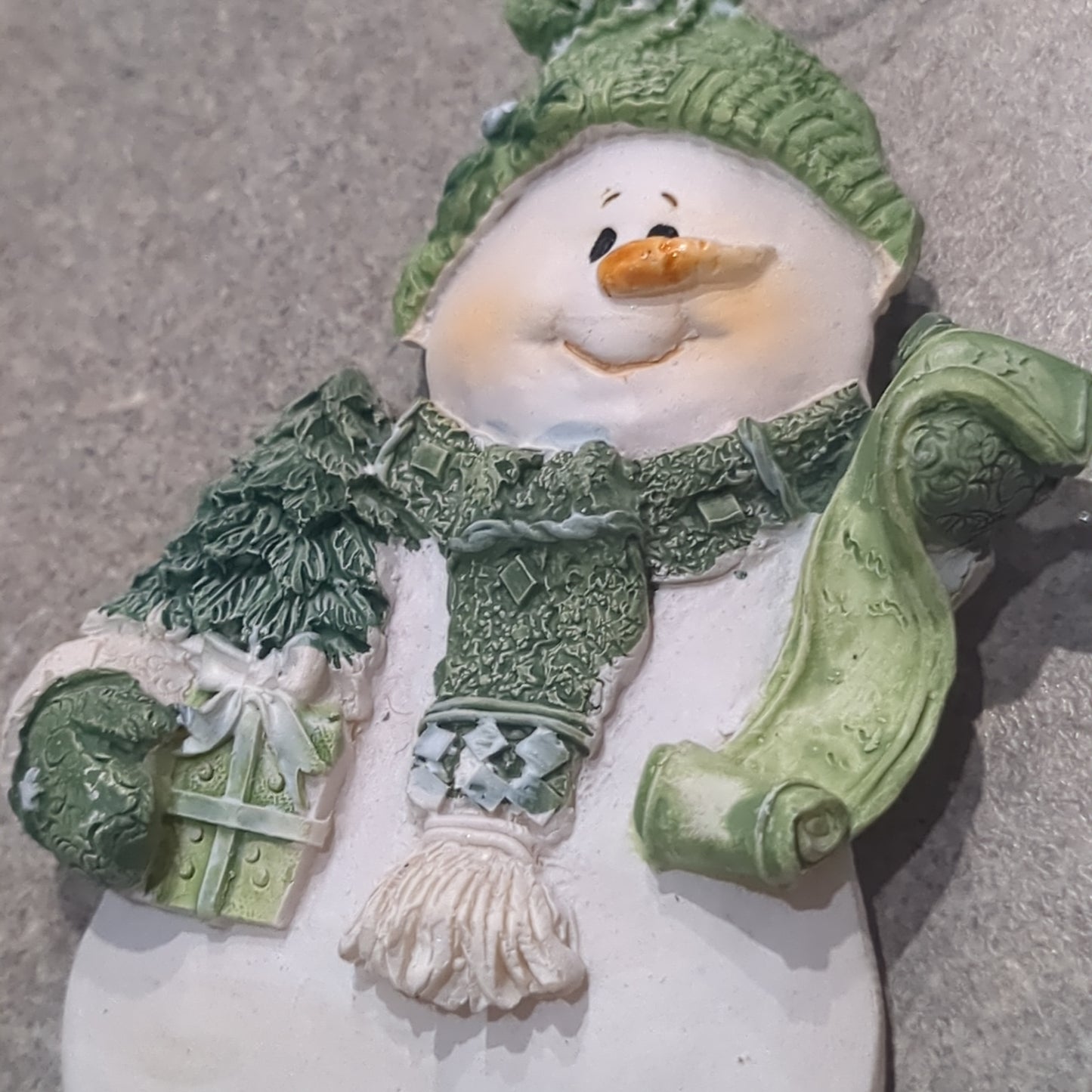 Polycrylic snowman ornament with a scroll and gift - green