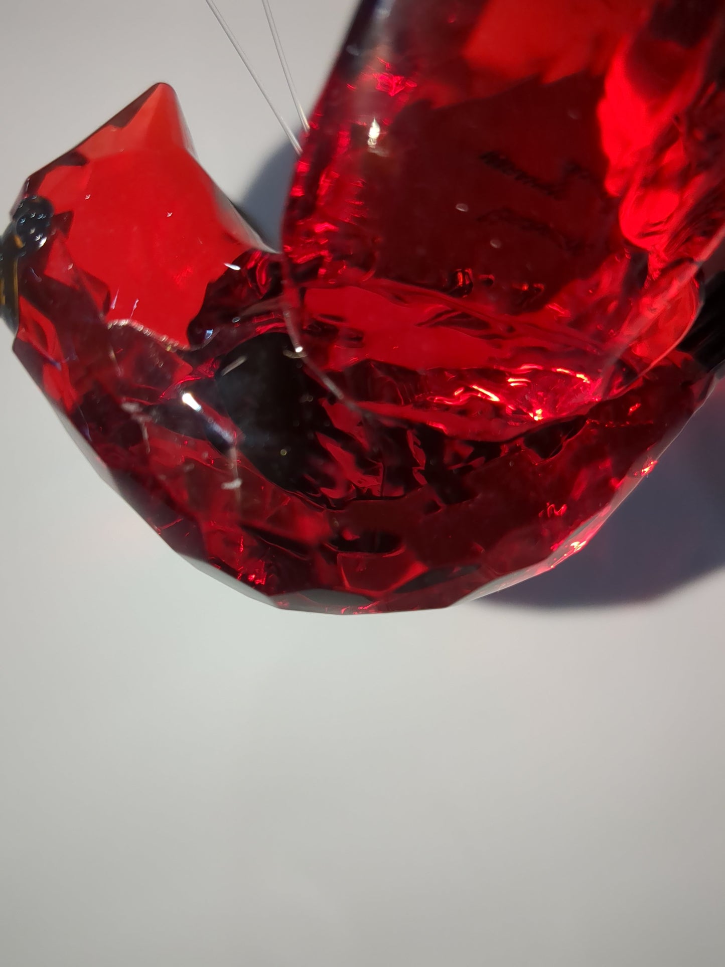 O77 Crystal Expressions Cardinal ornament with a charm.