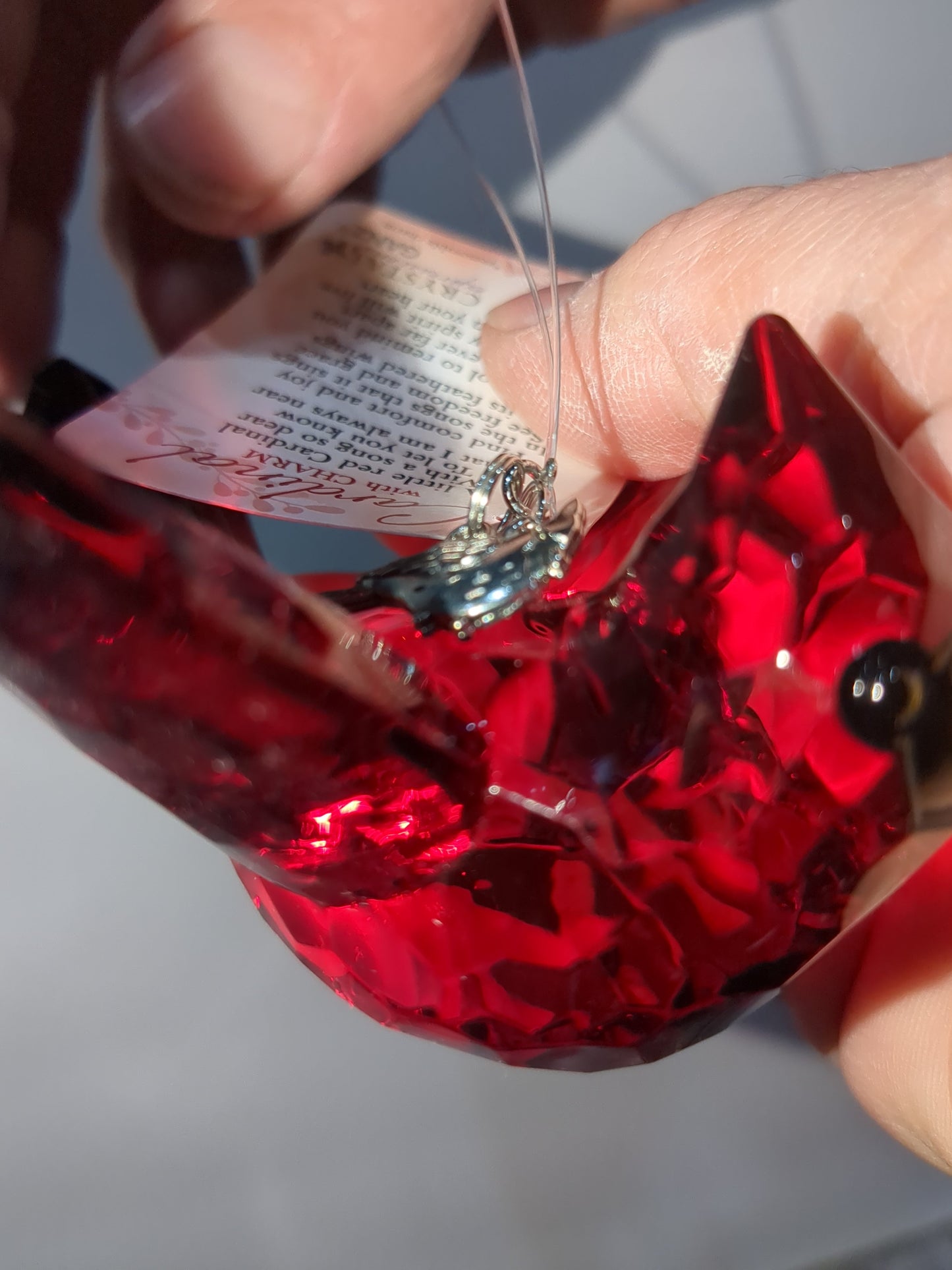 O77 Crystal Expressions Cardinal ornament with a charm.