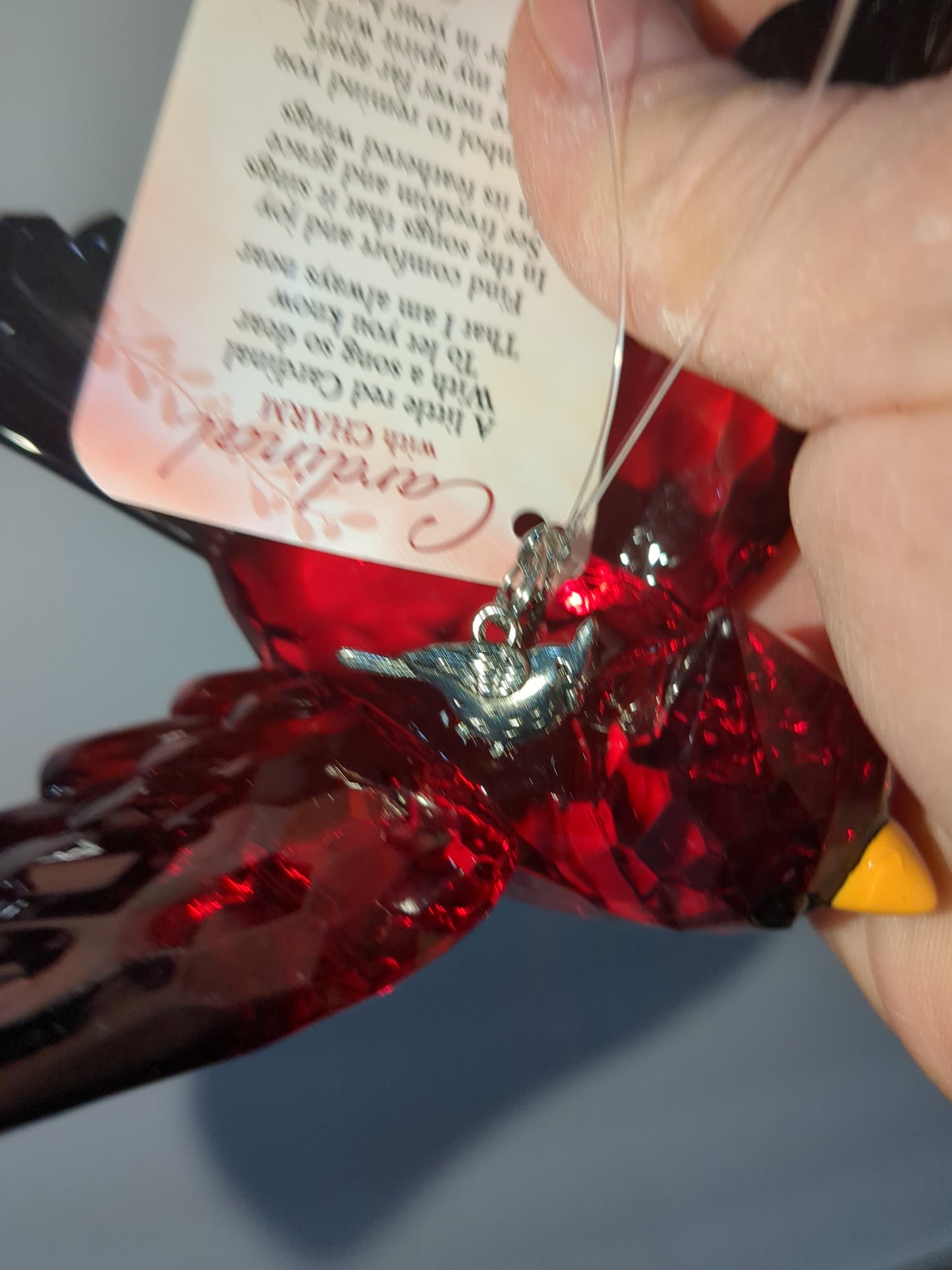 O77 Crystal Expressions Cardinal ornament with a charm.