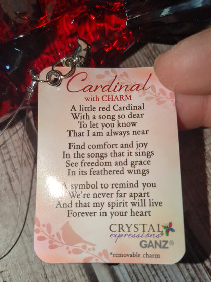 O77 Crystal Expressions Cardinal ornament with a charm.