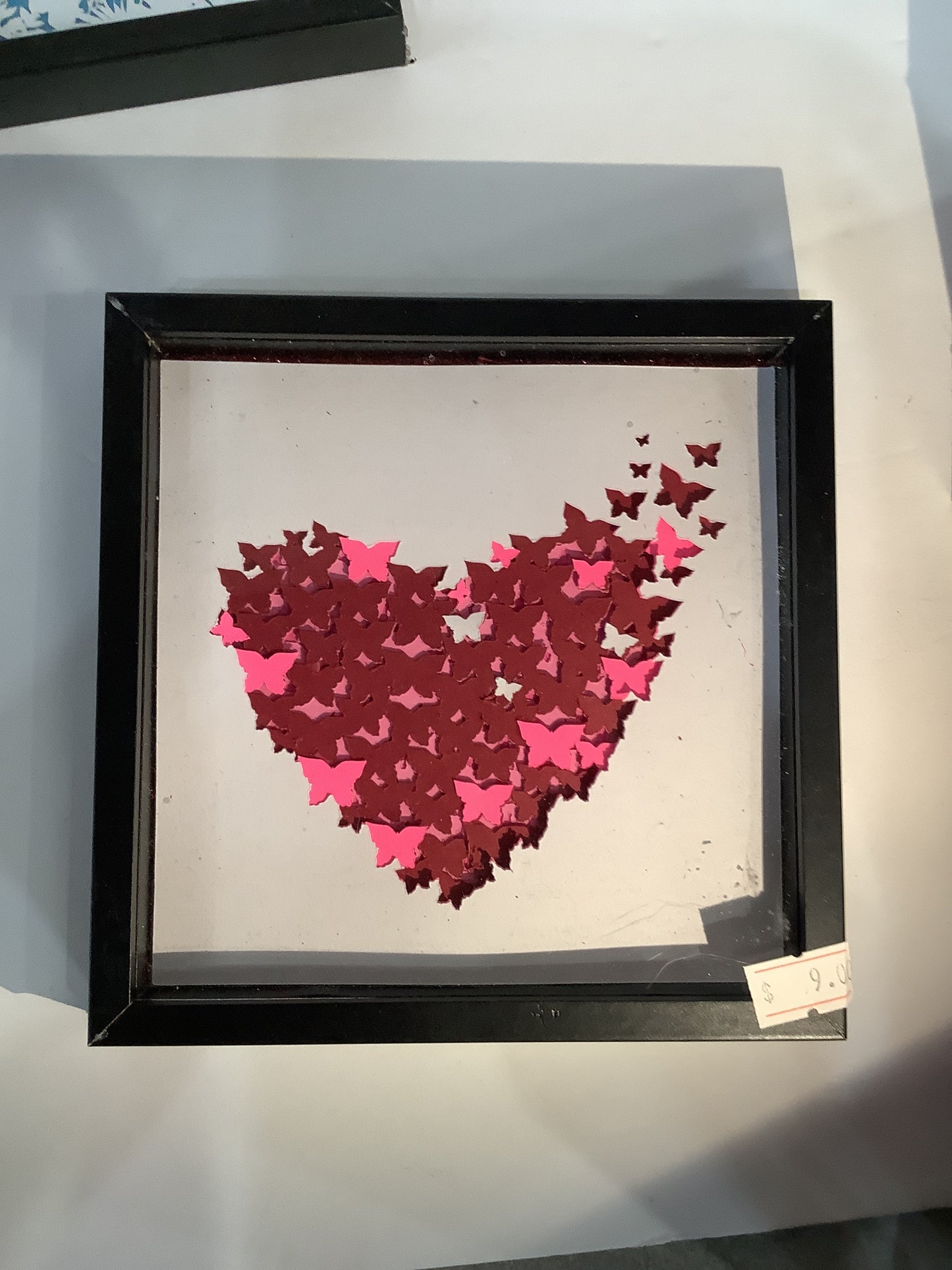 5 1/2 x 5 1/2 black shadow box with paper cut butterflies, turning into a heart
