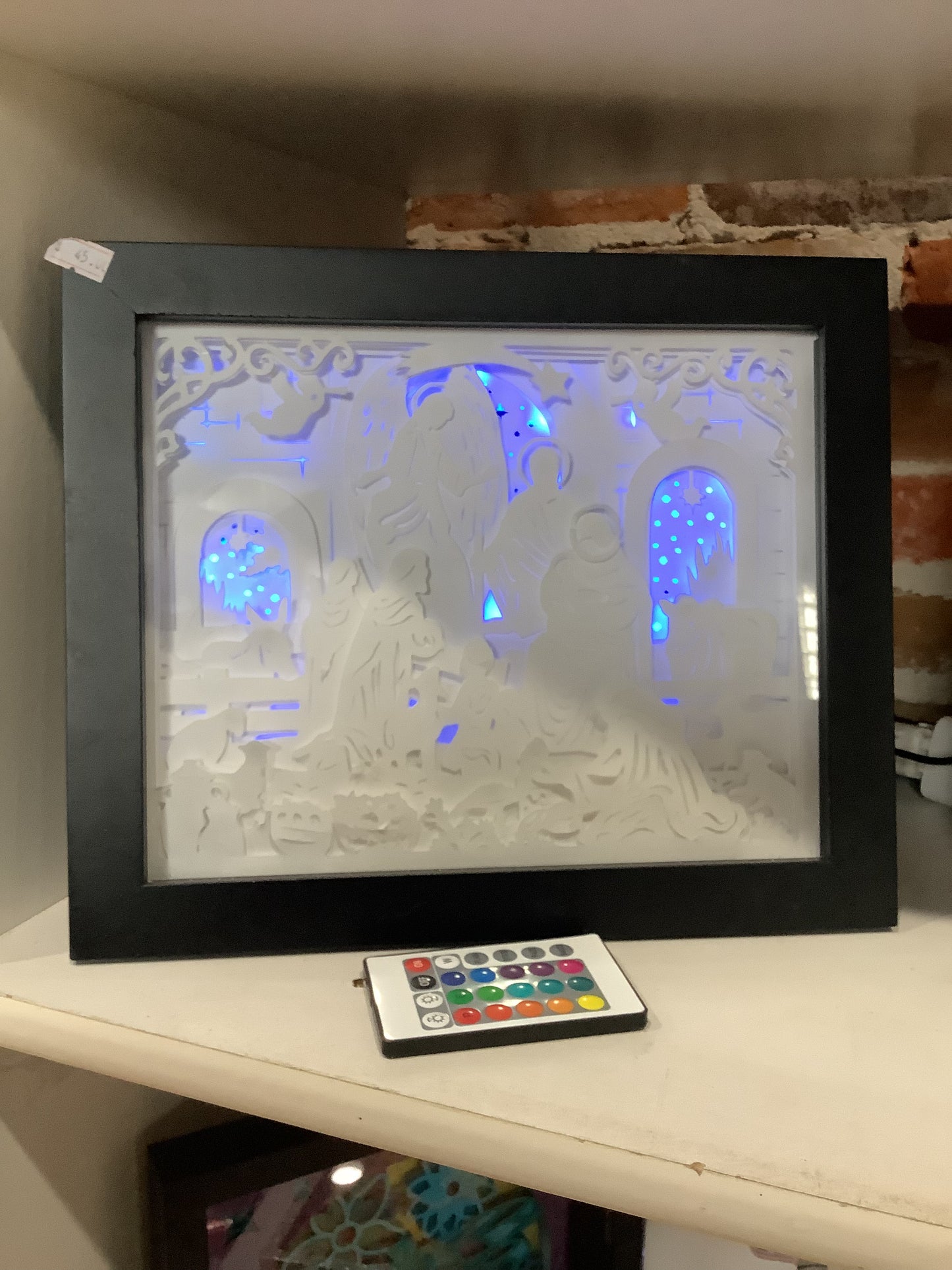 8 x 10” black shadowbox with paper cut nativity scene and lights