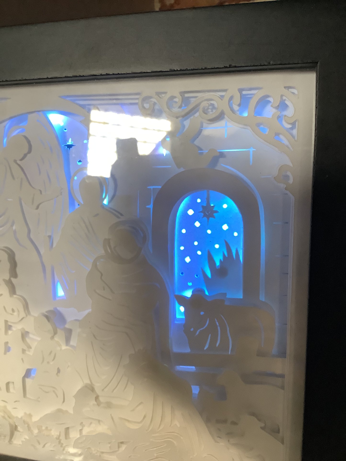 8 x 10” black shadowbox with paper cut nativity scene and lights