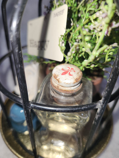 Assemblage light fixture, bottle, bird, plant, wood flower, flashcard