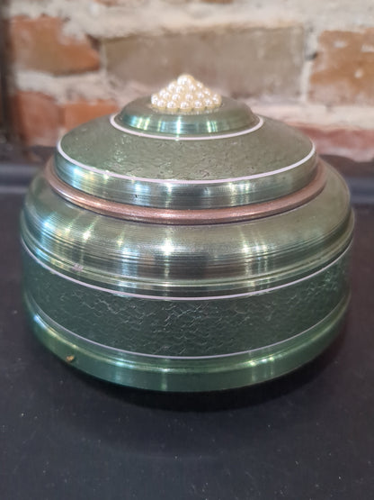 Vintage, round, aluminum, powder puff music box with faux pearls on top. Mb1